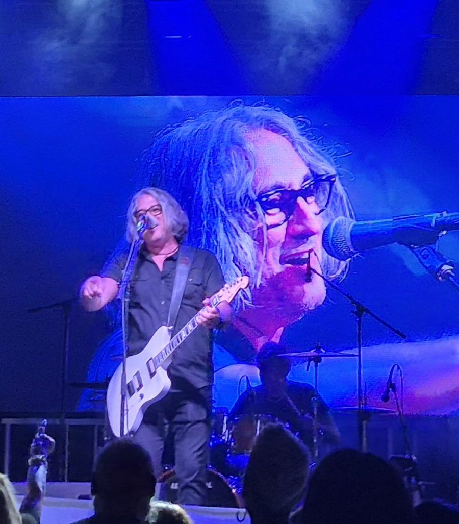 Singer on stage with a giant video-screen close-up behind him